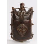 African carved container, with a figure to the lid above the strung body with a mask to the