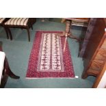 Middle Eastern style rug, the deep red ground with a multicolour geometric pattern surrounding a