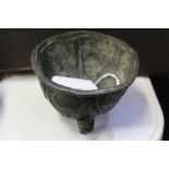 Small lead pot, the exterior with stylised foliate decoration, raised on three tapering feet, 8.