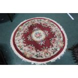 Circular Chinese carpet, the wine red ground with foliate decoration, 130cm diameter