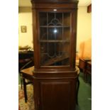 20th Century mahogany corner cupboard, the glazed doors opening to reveal three shelves, above a