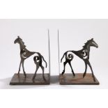 Pair of steel book ends, each with depiction of a horse with pierced scroll decoration, 21cm