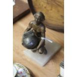 Art Deco table lighter, modelled as a kneeling female figure holding an orb form lighter, on an onyx