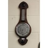 Barometer/ thermometer, housed in a carved oak case