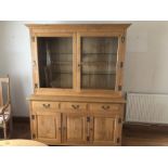 Light oak dresser, the cabinet with two glazed doors, opening to reveal two glass shelves, the