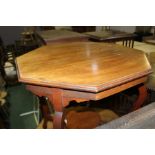 Edwardian mahogany centre table, the hexagonal top above arched legs, united by stretchers and an