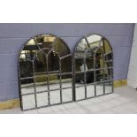 Pair of arched mirrors, held within metal frames, 92cm x 122cm