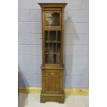 Oak display cabinet, in the form of a longcase cock case