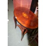 Edwardian mahogany centre table, the inlaid oval top above sabre legs, united by an inlaid under