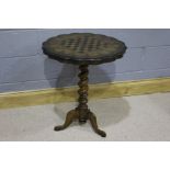 20th Century mahogany games table, the circular top above a turned twisted column, raised on three