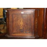 Victorian mahogany corner cabinet with marquetry inlay, the paneled door opening to reveal a