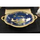 Carlton ware oval twin handled dish, the blue mottled ground with Oriental landscape decoration