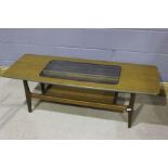 Mid 20th Century teak coffee table, the rectangular top with a glass cut out, above four tapering