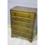 Early 20th Century oak chest of drawers, the top with an open gallery, above five drawers, raised on