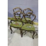 Four 19th Century balloon back chairs, the finely carved splat above period upholstered seats,