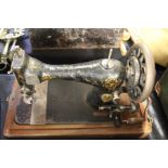 Singer hand operated sewing machine, housed in a carved domed case