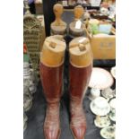Pair of brown leather riding boots, pair of black leather riding boots, both with wooden shoe