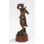 Spelter figure depicting a young lady holding a sprig of flowers and a candlestick, raised on a