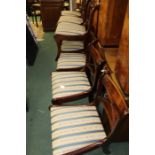 Set of twelve 20th Century dining chairs, the Sheraton style square backs raised on saber legs, with