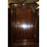 Victorian oak corner cupboard, the panelled door opening to reveal three green painted shelves, 71cm