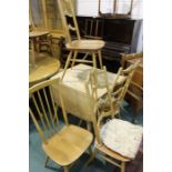 Unusual set of three Ercol 496 side chairs, the ladderbacks with splayed supports, raised on