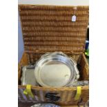 Plated ware, to include salvers, claret jug, dishes, trays etc. all housed in a wicker picnic