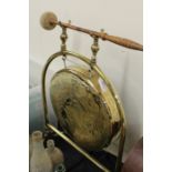 Brass dinner gong, the circular gong on an arched stand, with beater, 42cm wide