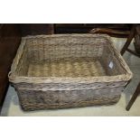 Large wicker laundry basket, mounted on wooden supports, 68cm x 47cm