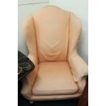 Late Victorian wing back armchair, on short cabriole legs, upholstered in green with a pink cover,