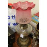 Victorian oil lamp by Benetfink, the ruby frosted glass shade with etched foliate decoration above a