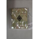 Mother of pearl card case, the diamond pattern exterior with vacant white metal cartouche to the