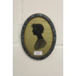 Early 20th Century silhouette, depicting a lady in profile, housed in a marble effect oval frame,