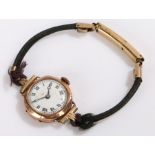 Ladies 9 carat gold wristwatch, the white dial with Roman numerals and faint retailers name,