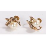 Pair of 9 carat gold and pearl earrings, the pearls set amongst stylised foliage, with screw