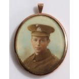 9 carat gold locket pendant, one side with depiction of a First World War soldier, the opposing side