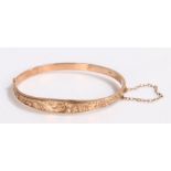 9 carat gold bangle, with leaf decoration and attached security chain, 5.7g