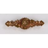 15 carat gold brooch, with central diamond chip surrounded by foliate decoration, 2.9g