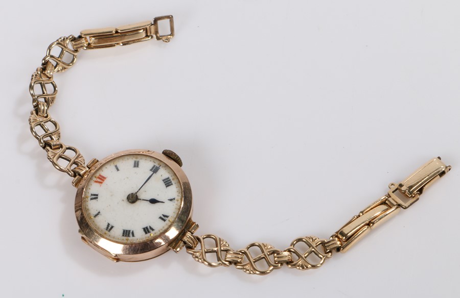 9 carat gold ladies wristwatch, the white dial with Roman numerals, manual wound, on a rolled gold