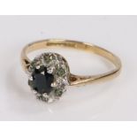 9 carat gold ring, set with a central sapphire surrounded by clear paste, ring size K, 1.5g