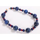 Lapis lazuli and ruby bead necklace, the large beads measuring approximately 20mm diameter, 45cm