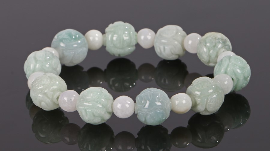 Jade bracelet, with carved pale green beads and white beads