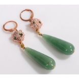 Pair of jade earrings, the teardrop jade drops above paste set panther heads