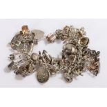 Silver charm bracelet set with 35 charms, 98.3g