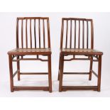 Pair of Chinese hardwood chairs, possibly hongmu wood, Qing Dynasty, the stepped top rail above a
