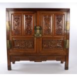 Chinese Huanghuali cabinet, the rectangular top above a pair of carved panel doors with flowers