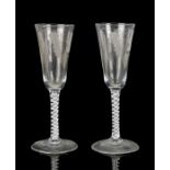 Pair of George II 18th Century ale glasses, circa 1750, the tall round funnel bowl engraved with