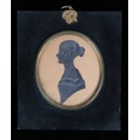 Mid 19th Century silhouette of a lady, with her hair in a bun with grey painted highlights to the