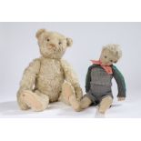 Early 20th Century straw filled doll, of a boy, together with a teddy bear in light colour, the