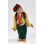 Early 20th Century straw filled monkey teddy, dressed in a bright costume, 61cm long