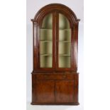 George II walnut corner cabinet, the arched concave cornice above a pair of arched glazed doors